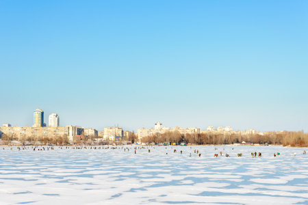 Kiev/Ukraine - January 07, 2015 -The Dnieper river is frozen. Hundred of fishermen go to catch some...