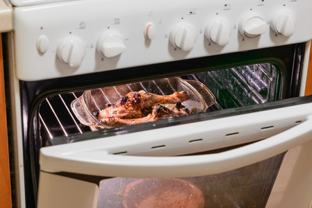 Legs of roast chicken being cooked in a warm ovenの写真素材