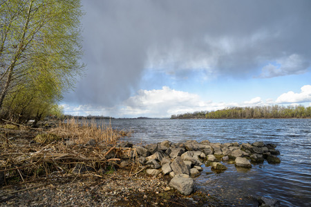 Heavy clouds in the sky over the Dnieper river announce the incoming of a spring storm