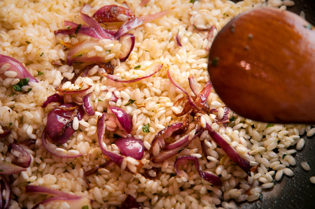 Closeup of risotto with red onions, cooked in a panの写真素材