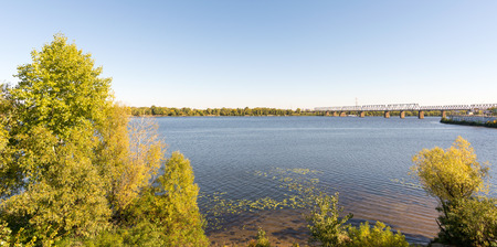 The Dnieper river and the Kiev's Petrovskyi railway bridge. It was built in 1929. During the Great Patriotic War it was ruined and restored after Kyiv liberation.の写真素材