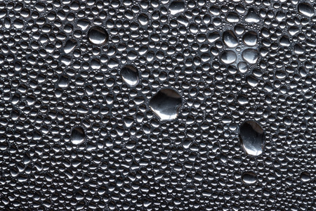 Many little water drops due to condensation on a plastic bottle curved surfaceの写真素材
