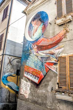 Saludecio/Italy - March 15, 2005: A mural painting in Saludecio illustrating the invention of the accordion by the German Buchman and perfectioned by the Austrian Damian in 1822のeditorial素材