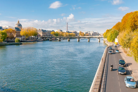 Paris/France - October 5, 2009: The Seine, the French Academy, the Pont des Arts and the Eiffel tower seen from the Pont Neuf in Paris. Houseboats moored at the dock.のeditorial素材