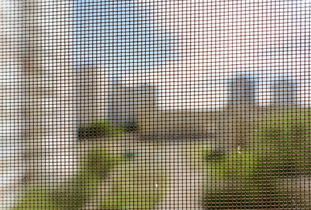 Open window with a mosquito screen to prevent insects and bugs, like flies, bees, mosquitoes or...