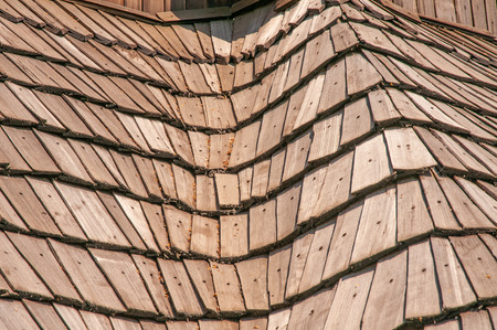 Roof made of wooden tiles under the sun.This typical Ukrainian and Russian structure creates a nice...