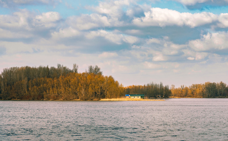 Little house close to the Dnieper river in Kiev, Ukraine, at the beginning of spring, under a cloudy skyの写真素材