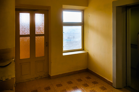 High floor level. Exit of elevator and door window overlooking the safety stairs in a Kiev building in Ukraineの写真素材