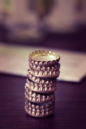 Beer or other soda and soft drinks caps, on a dark wood table in a  bar or a pubの写真素材