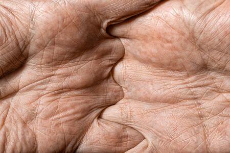 Color photo of senior man hands with crossed fingersの写真素材