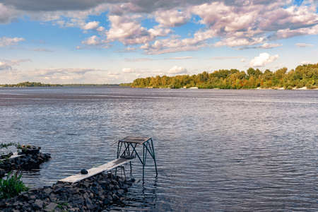 View of a pontoon on the Dnieper river in Kiev, Ukraine. Soft white clouds move in the blue summer skyの写真素材