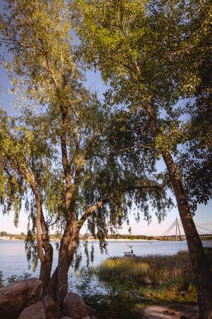 Kiev / Ukraine - September 11, 2020 - Fisherman on the Dnieper River in Kiev, Ukraine during a nice sunny afternoon of summerの写真素材