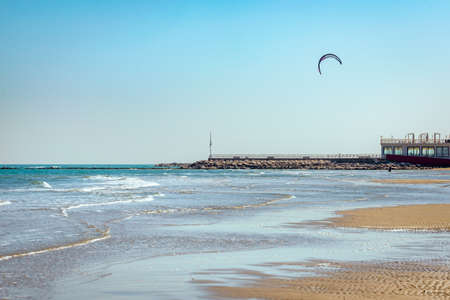 Kite surfing in Pesaro, Marche region of Italy, on the Adriatic sea during a sunny and windy summer dayの写真素材