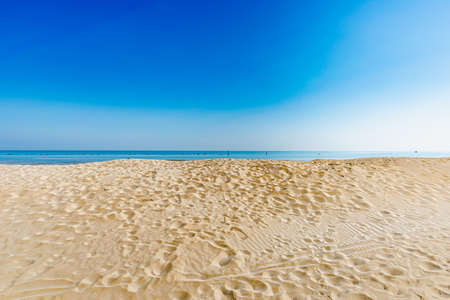 View of the Adriatic Sea from the sandy beach in Pesaro, Italy, during a sunny spring dayの写真素材