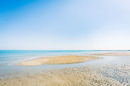 View of the Adriatic Sea from the sandy beach in Pesaro, Italy, during a sunny spring dayの写真素材