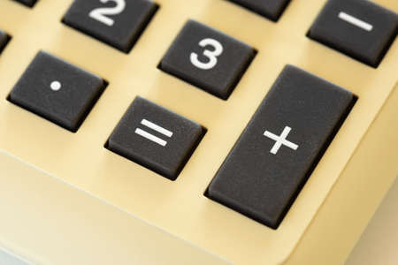 Detail of an old home calculator isolated on white backghroundの写真素材