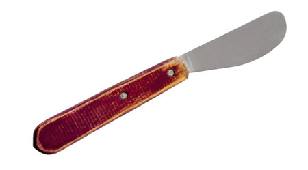 Old butter spreader knife with brown wooden handle isolated on white backgroundの写真素材