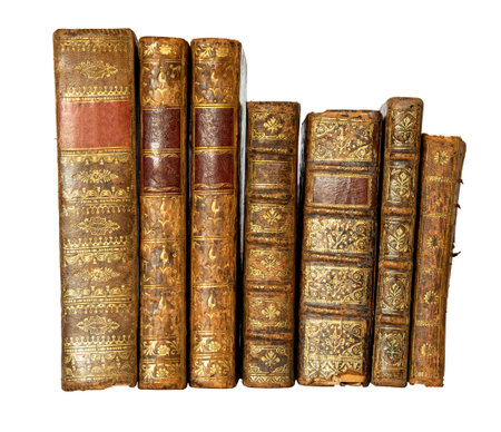 Row of antique books with a leather cover and golden ornaments on isolated on white backgroundの写真素材