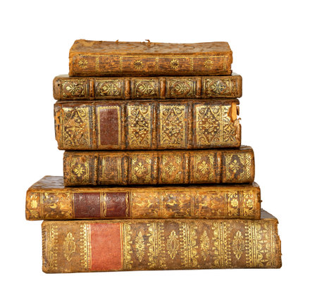 Pile of antique books with a leather cover and golden ornaments on isolated on white backgroundの写真素材
