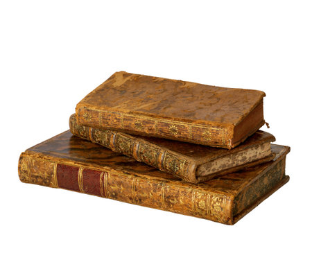 Pile of antique books with a leather cover and golden ornaments on isolated on white backgroundの写真素材