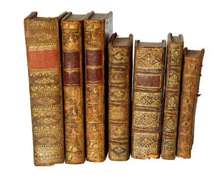 Row of antique books with a leather cover and golden ornaments on isolated on white backgroundの写真素材