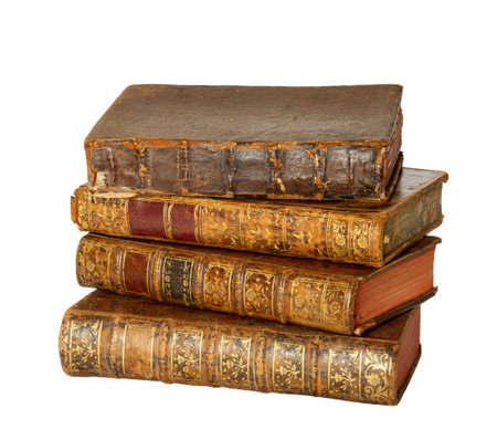 Pile of antique books with a leather cover and golden ornaments on isolated on white backgroundの写真素材