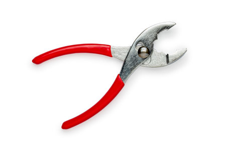 Open slip joint pliers with red handles, anti-magnetic titanium, isolated on white backgroundの写真素材