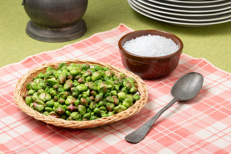 Caper buds in a basket and big sea salt on a table. Ready to be prepared for seasoning and picklesの写真素材