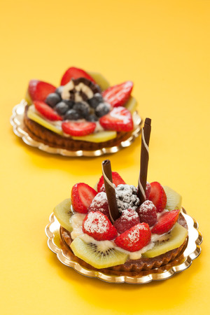 Italian pastry with strawberries blackberries kiwi raspberry cream and chocolateの写真素材