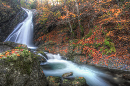 Waterfalls in the forest in autumnの写真素材