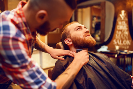 Time for a new hairdo. Handsome young bearded man came to the barber for a haircut. hipster style.の写真素材