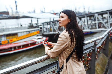 Beautiful stylish girl walks in the city of Norway on a sunny day. Young women enjoy.の写真素材