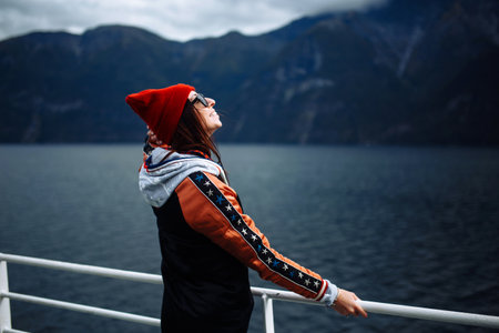 Smiling girl on a ferry. Young woman enjoys a ferry ride on summer vacation in sunny day.
