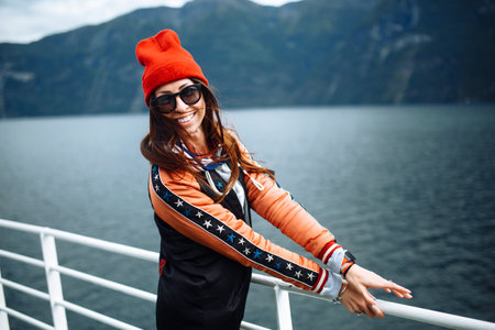 Smiling girl on a ferry. Young woman enjoys a ferry ride on summer vacation in sunny day.の写真素材