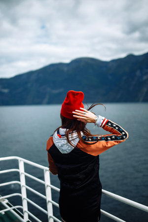 Stylish woman takes a photo on the phone in the travelling. The girl tourist photos.
