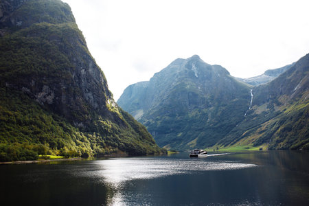 A ship sailing in Norwegian fjords. Amazing nature view with fjord and mountains. beautiful reflection.の写真素材