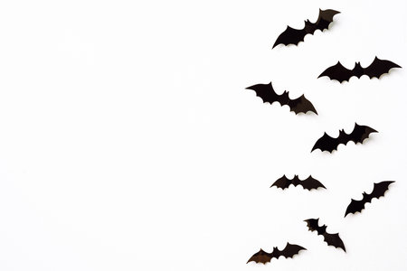 halloween and decoration concept - black 3d paper bats flying over white background.の写真素材