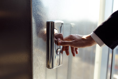Man pressing elevator button. finger presses the elevator button. red button. sunset light.