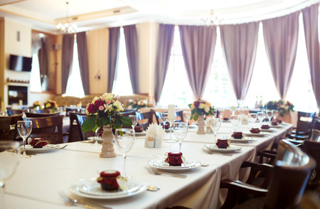 Beautiful table setting with crockery and flowers for a party, wedding reception or other festive event.の写真素材