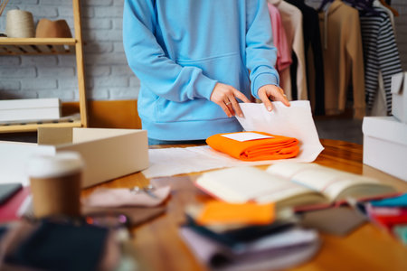 Small business owner, entrepreneur, seller using tablet checking ecommerce clothing store orders.の写真素材