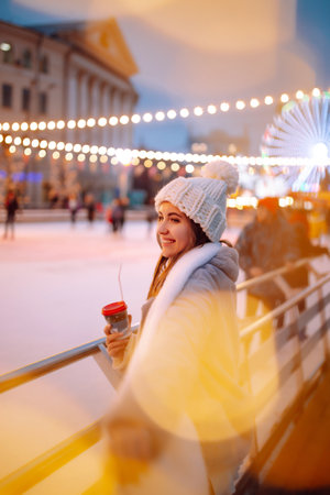 Young woman ice skating on the ice arena in the city square in winter on Christmas Eve. winter holiday.の素材 [FY310192678489]