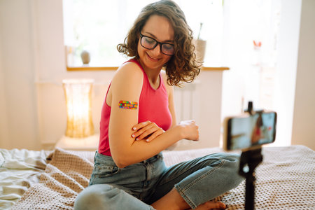 Woman blogger videotapes her vlog at home and speaking about Vaccine for covid-19.の写真素材