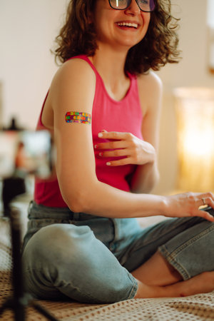Woman blogger videotapes her vlog at home and speaking about Vaccine for covid-19.の写真素材