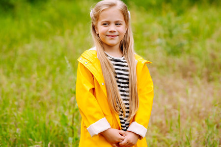 Cute little girl picking wildflowers in the meadow. A child explore nature.