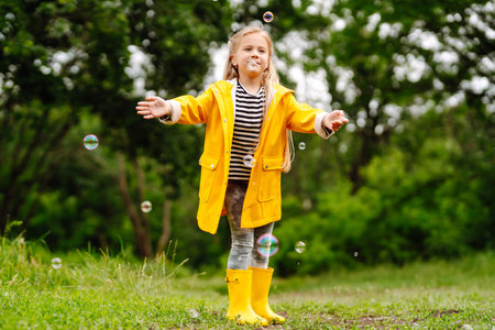 Cute little girl picking wildflowers in the meadow. A child explore nature.の写真素材