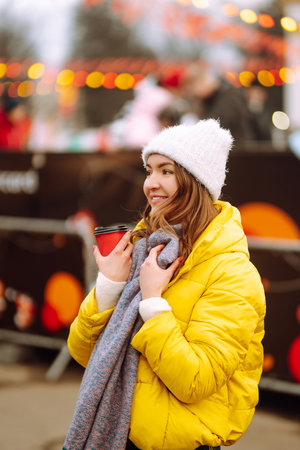 Happy woman ice skating on the ice arena in the city square on Festive Christmas fair. cold weather.の写真素材