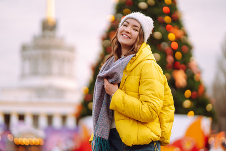 Happy woman ice skating on the ice arena in the city square on Festive Christmas fair. cold weather.の写真素材