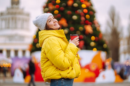 Happy woman ice skating on the ice arena in the city square on Festive Christmas fair. cold weather.の写真素材