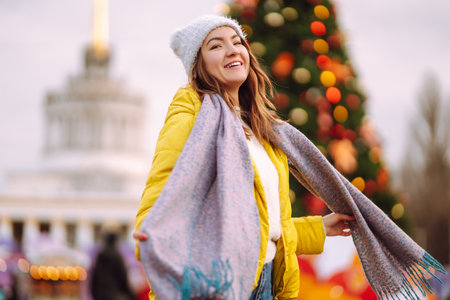 Happy woman ice skating on the ice arena in the city square on Festive Christmas fair. cold weather.の写真素材