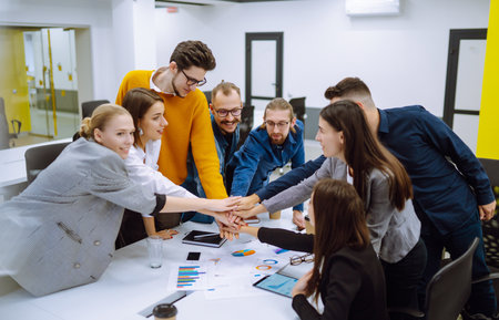 Young business people demonstrating unity with their own hands.